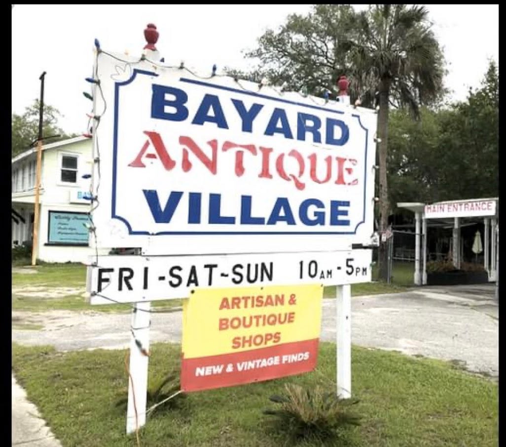 The Bayard Antique Village roadside sign on Philips Highway